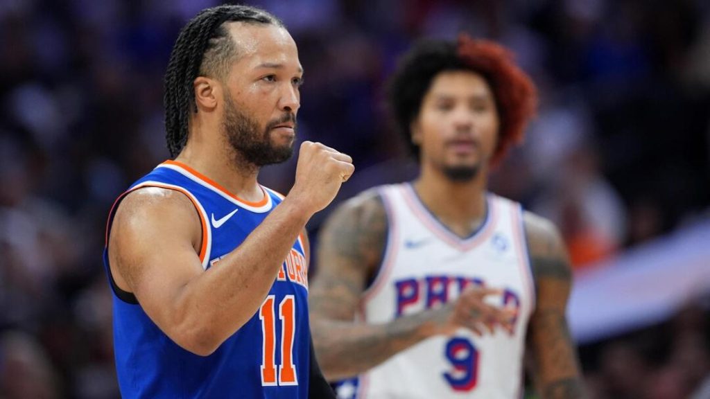 knicks happy 1 - Digital Wager Wire A basketball player in a blue orange jersey (number 11) raises his fist, on a court with another player blurred in the background.