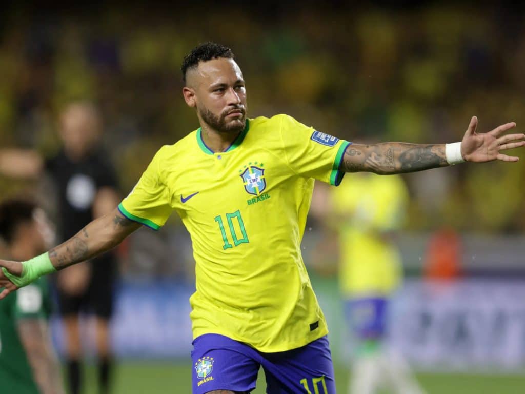 neymar scores - Digital Wager Wire Brazilian national team footballer in a yellow jersey with number 10, arms outstretched on the field during a match.
